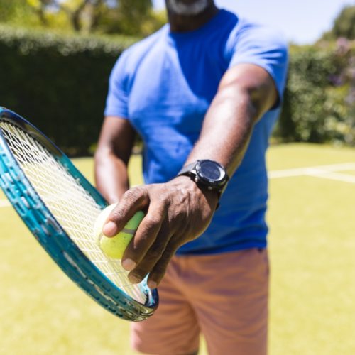 Midsection,Of,Senior,African,American,Man,Playing,Tennis,Preparing,To